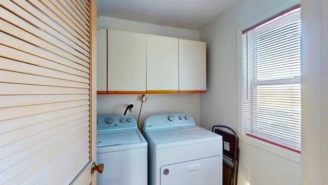 laundry room featuring separate washer and dryer and cabinet space