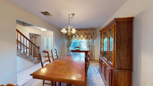 dining space with a chandelier, visible vents, french doors, and stairs