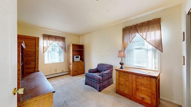 living area with baseboard heating and light colored carpet