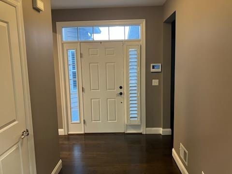 entryway featuring visible vents, baseboards, and dark wood-style flooring