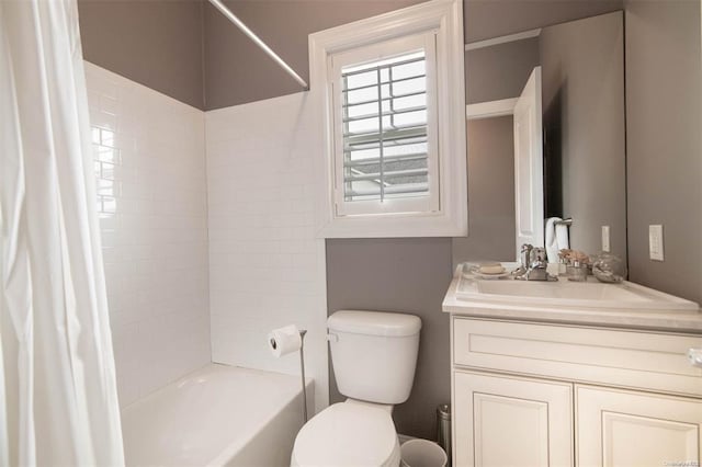 bathroom featuring vanity, shower / tub combo, and toilet