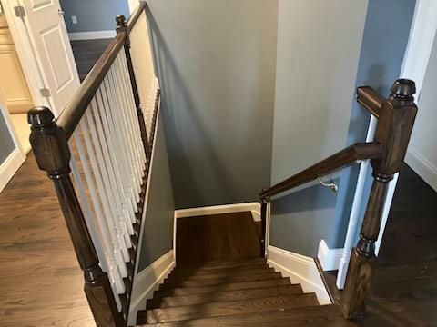 stairway with baseboards and wood finished floors