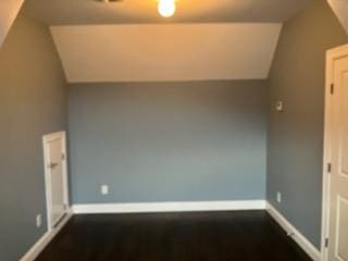 bonus room with baseboards and lofted ceiling