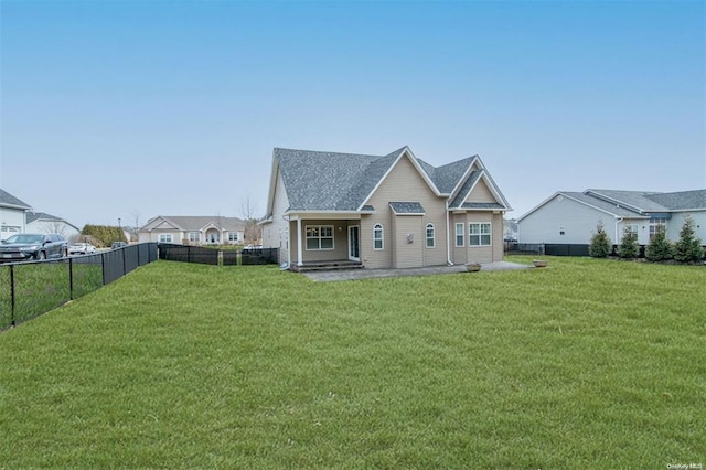 back of property featuring a lawn and a fenced backyard