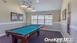 game room featuring carpet flooring, pool table, baseboards, and lofted ceiling