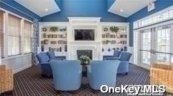 carpeted living area featuring a fireplace and vaulted ceiling