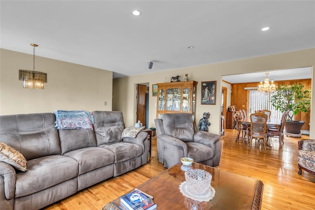 living room with a chandelier, recessed lighting, and light wood-type flooring