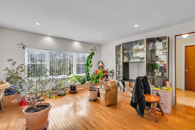 living area featuring recessed lighting and hardwood / wood-style floors