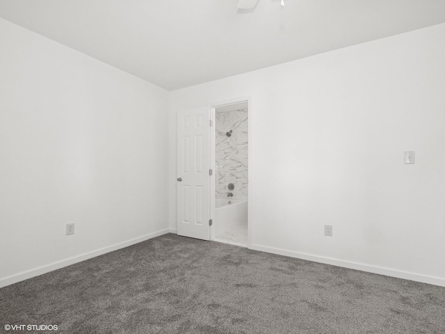 empty room featuring baseboards and carpet