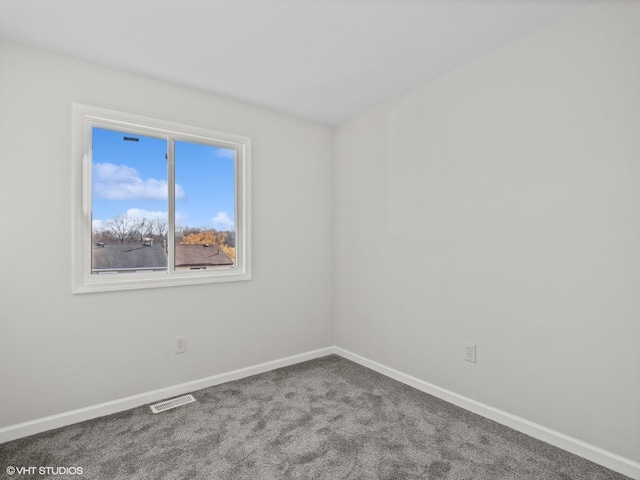 unfurnished room featuring carpet flooring, baseboards, and visible vents