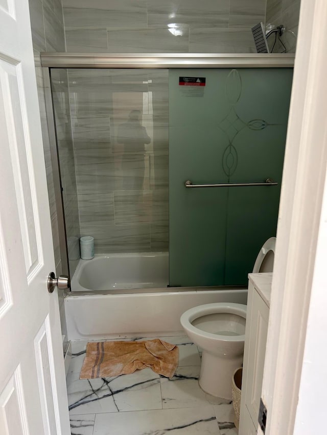 bathroom with toilet, marble finish floor, and enclosed tub / shower combo