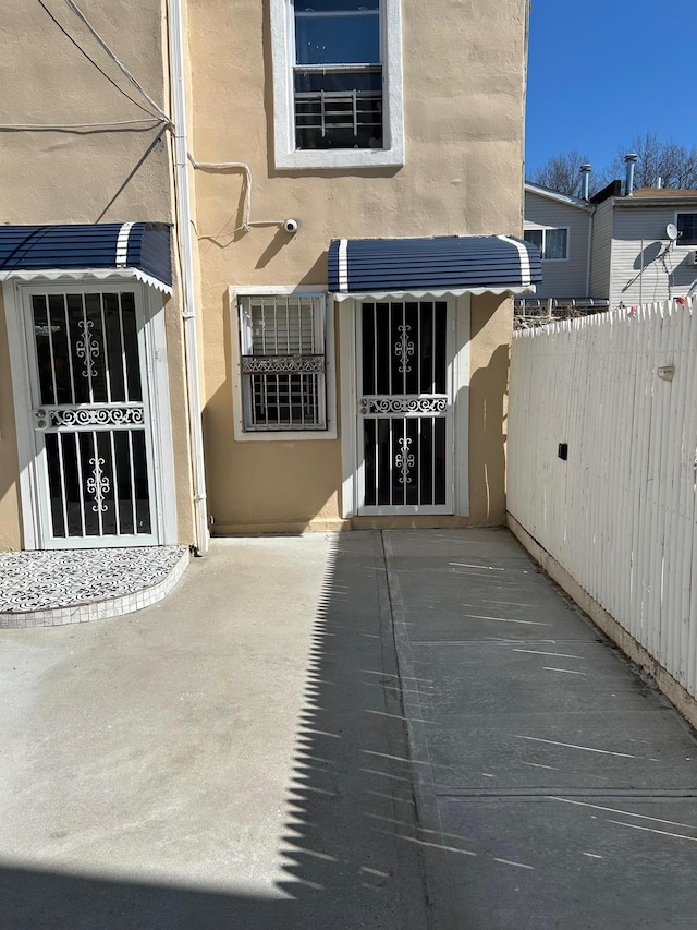 exterior space with fence and stucco siding