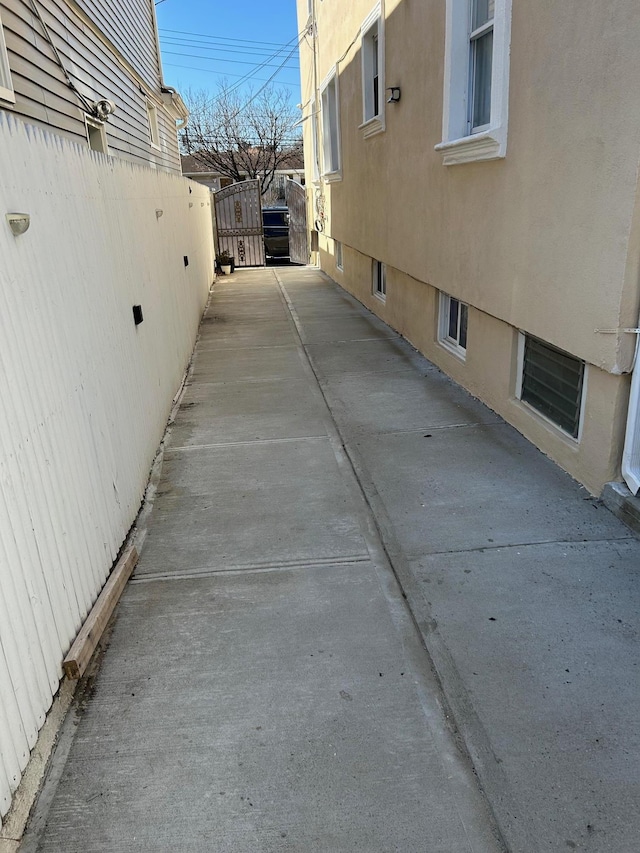 view of property exterior featuring a patio area and fence