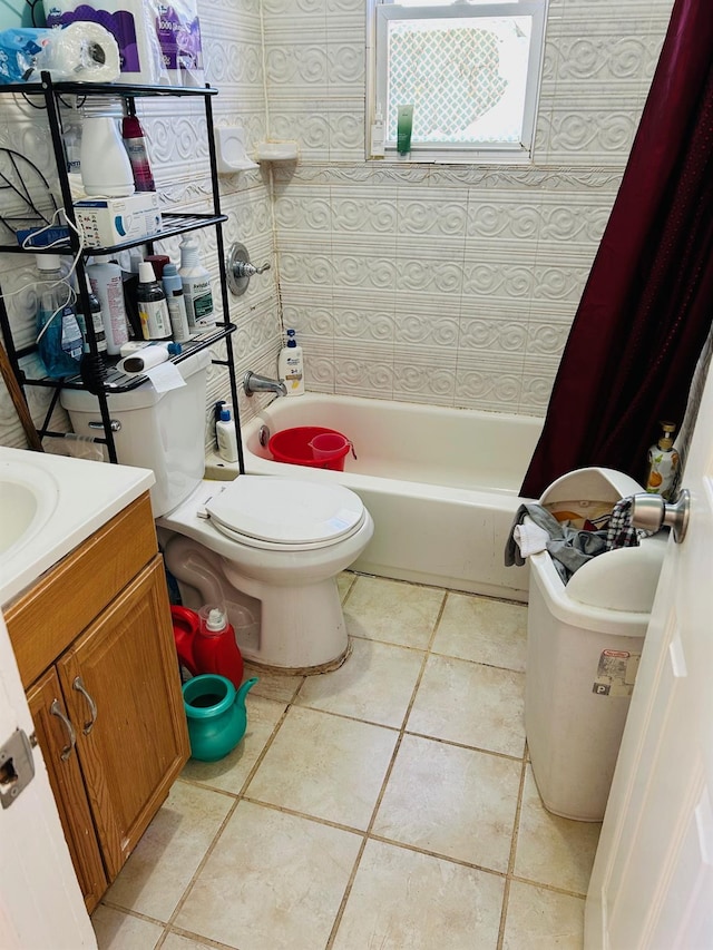 full bath with tile patterned floors, vanity, toilet, and shower / tub combo with curtain