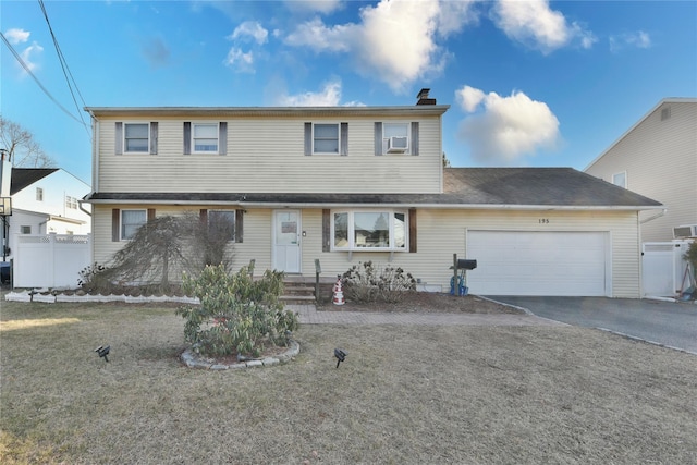 195 Maple Ave, Bethpage, NY 11714 - traditional-style house featuring an attached garage, fence, driveway, and a chimney