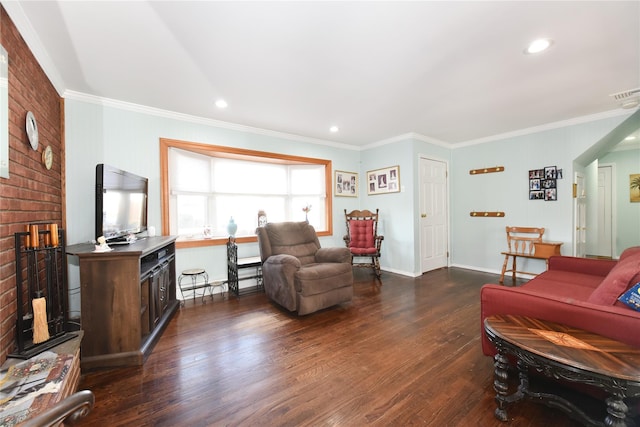 living room with dark wood finished floors, visible vents, a brick fireplace, and ornamental molding