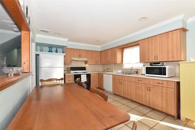 kitchen featuring visible vents, crown molding, under cabinet range hood, white appliances, and a sink