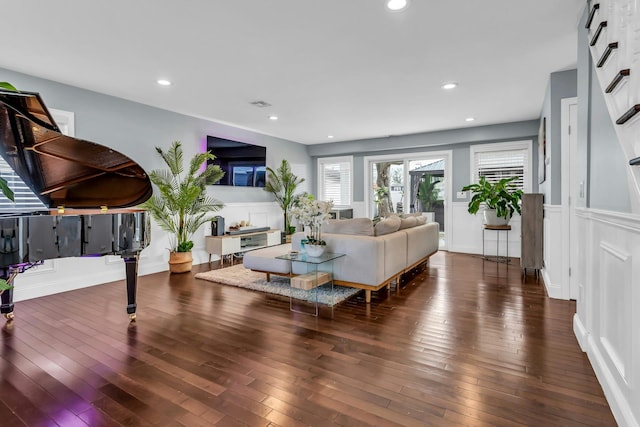 living area with recessed lighting, visible vents, and wood-type flooring