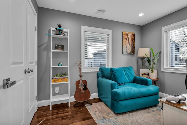 sitting room with dark wood-style floors, visible vents, recessed lighting, and baseboards