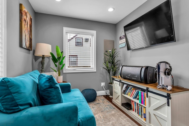 living area featuring recessed lighting, wood finished floors, and baseboards