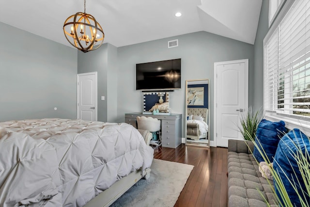 bedroom with hardwood / wood-style floors, lofted ceiling, visible vents, and a chandelier