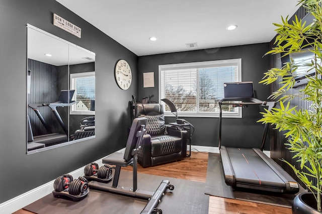 exercise room with visible vents, recessed lighting, wood finished floors, and baseboards