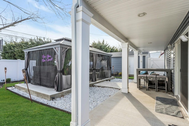 view of patio with a gazebo and fence