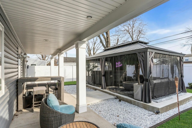 view of patio / terrace with a gazebo and fence private yard