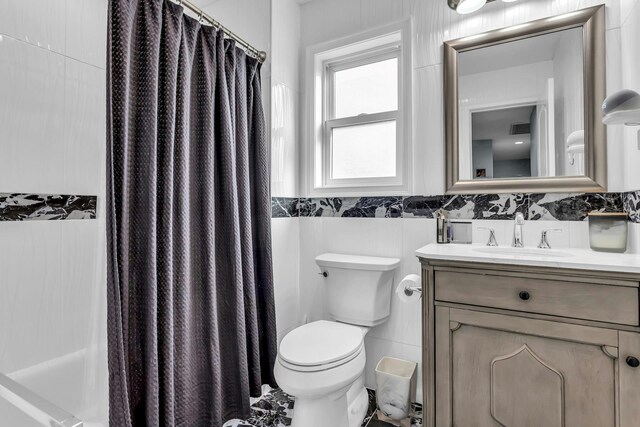 106 Hickory Ln, Levittown, NY 11756 - bathroom featuring visible vents, curtained shower, toilet, vanity, and tile walls