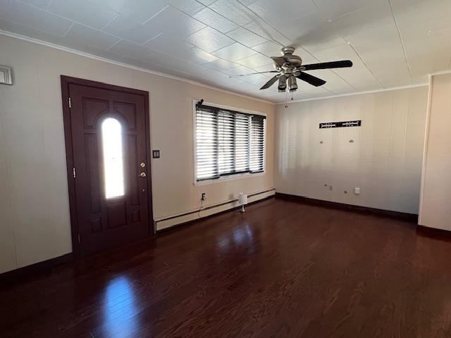 entryway featuring baseboard heating, crown molding, a ceiling fan, and wood finished floors