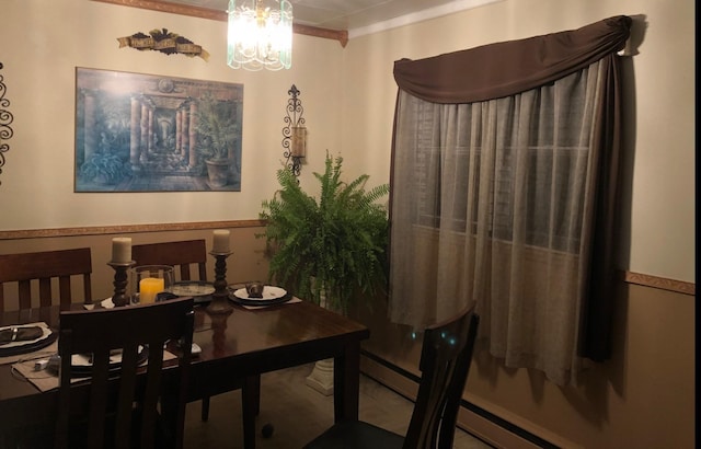 dining room featuring ornamental molding, a baseboard radiator, and a chandelier