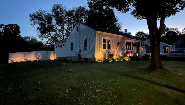 view of front of home with a front yard and fence