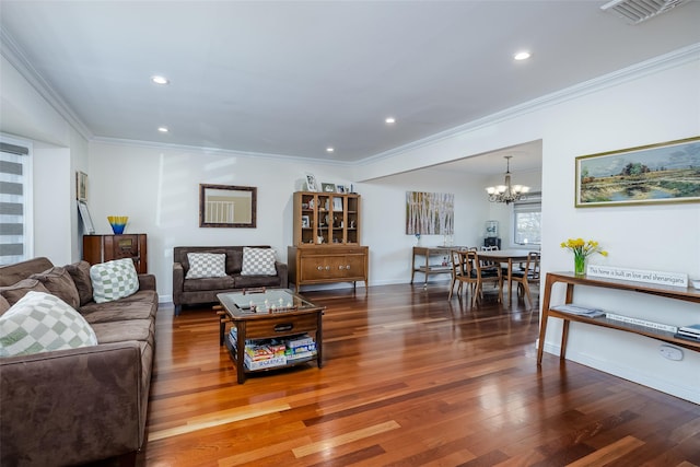 living room featuring wood finished floors, visible vents, recessed lighting, ornamental molding, and a notable chandelier