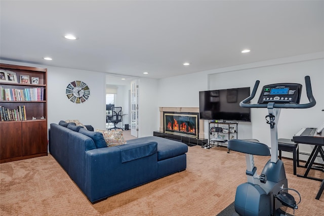 living area featuring a tiled fireplace, recessed lighting, and carpet floors