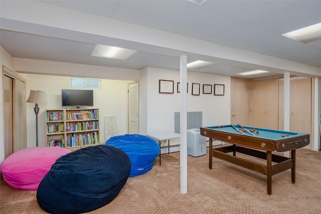 rec room with visible vents, light colored carpet, and a baseboard heating unit