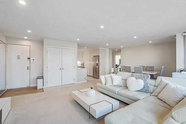 living room featuring recessed lighting and light carpet