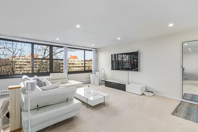 living room featuring carpet flooring, recessed lighting, and baseboards