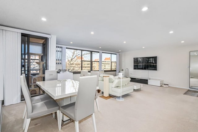 dining room with recessed lighting and light colored carpet