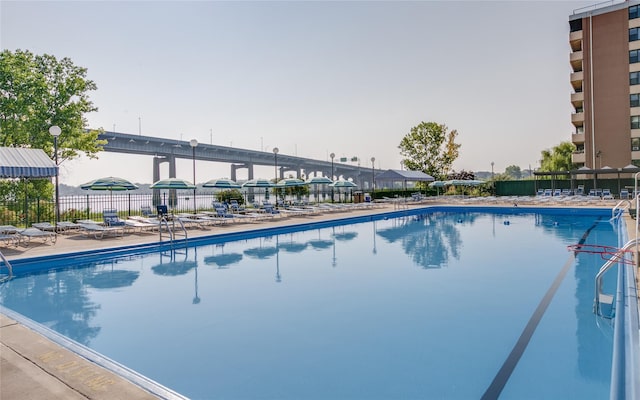 community pool featuring a patio and fence