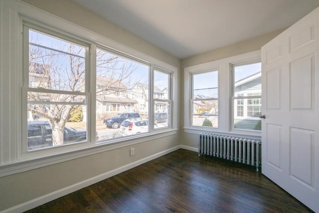 unfurnished sunroom featuring radiator