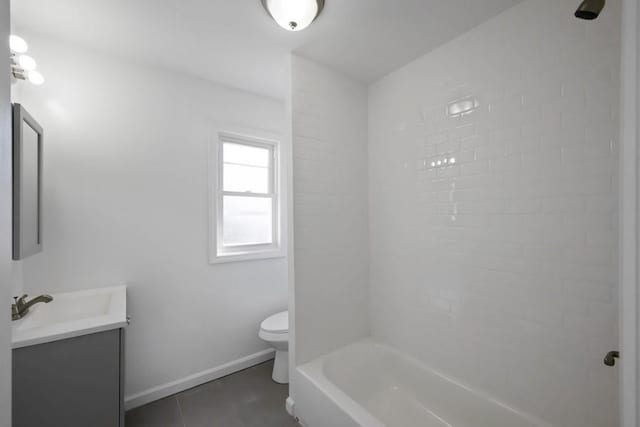 bathroom with vanity, washtub / shower combination, baseboards, tile patterned floors, and toilet