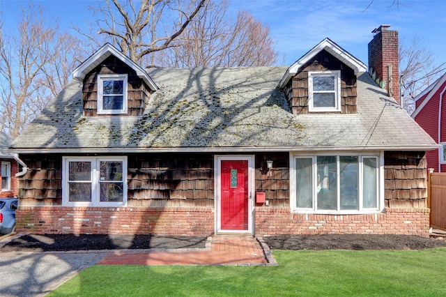 view of front of property with a front lawn and a chimney