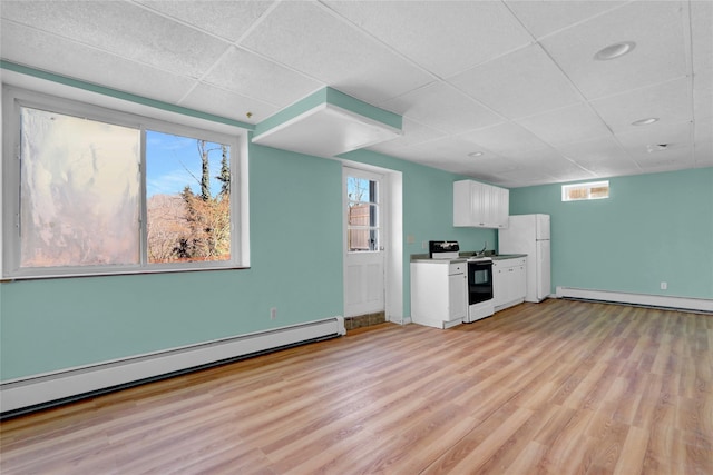 kitchen featuring electric range, white cabinetry, light wood-style floors, and a baseboard radiator