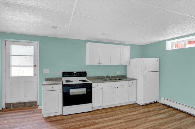 kitchen with light wood-style flooring, a sink, a baseboard heating unit, electric range oven, and freestanding refrigerator