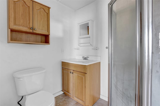 full bathroom featuring vanity, baseboards, a shower stall, tile patterned floors, and toilet