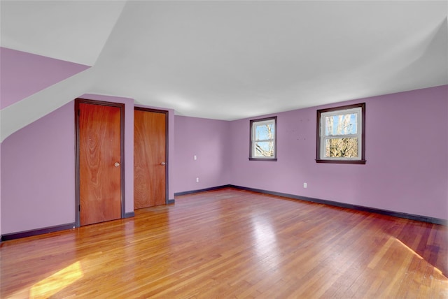 interior space featuring light wood-type flooring and baseboards