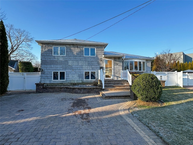 split level home with fence and a gate