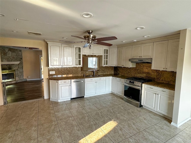 kitchen with ceiling fan, dark countertops, and stainless steel appliances