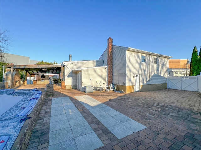 exterior space with fence, a patio, and a gate