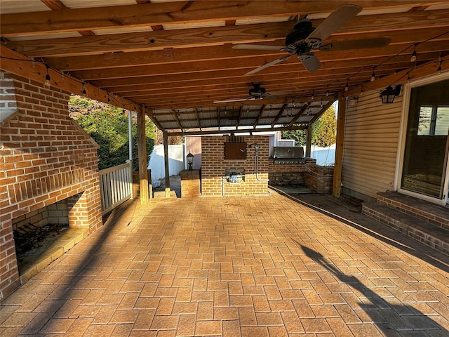 view of patio with exterior kitchen and a ceiling fan